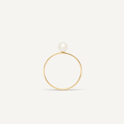 Thin gold pinkie ring featuring a white small pearl designed for everyday wear.  
