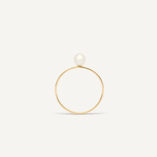 Thin gold pinkie ring featuring a white small pearl designed for everyday wear.  
