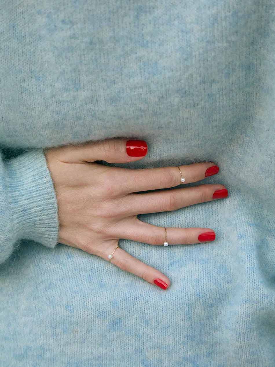 Thin gold pinkie ring featuring a white small pearl designed for everyday wear.  