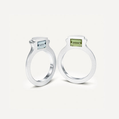 Silver signet ring with gemstones in 2 halves of the ring on the side.