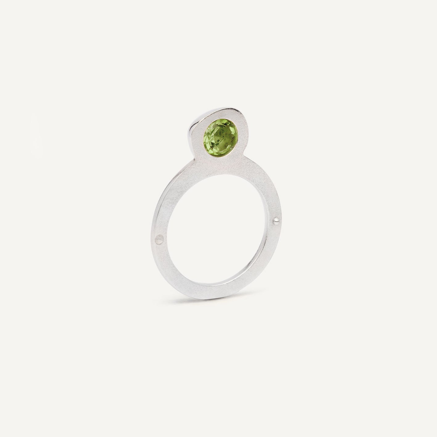 Silver signet ring with Peridot in 1 half of the ring. 