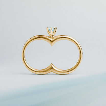 A gold plated silver ring with a double circle and a blue gemstone designed for two fingers.