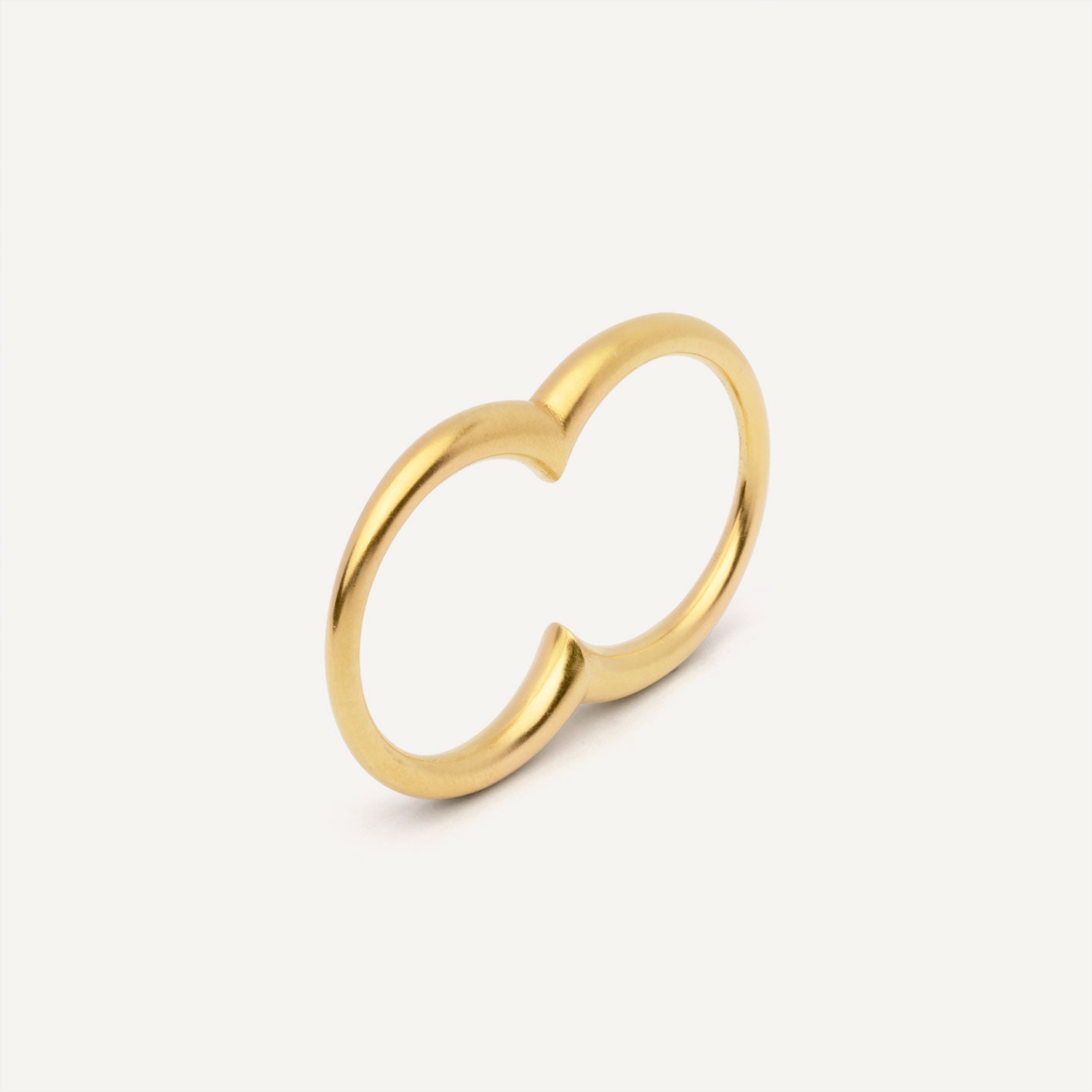 A gold plated silver ring with a double circle design for two fingers.