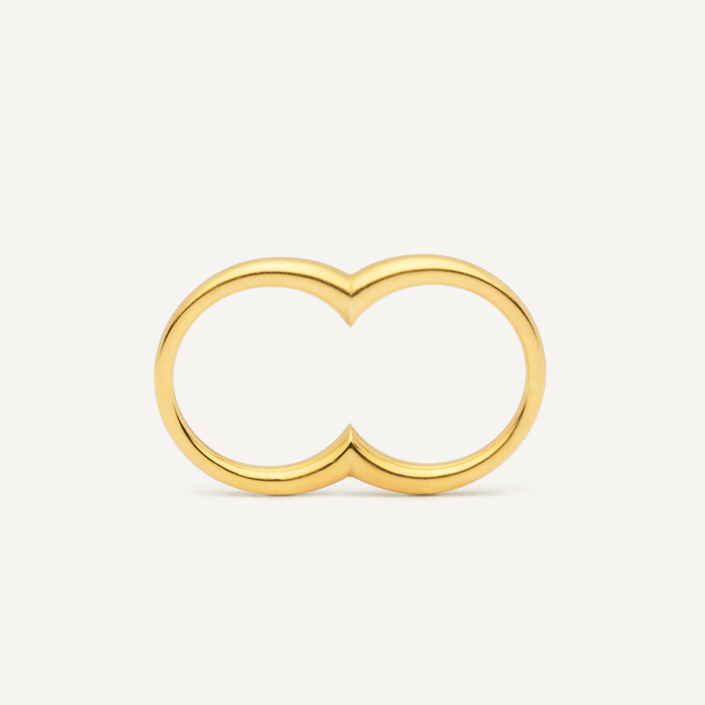 A gold plated silver ring with a double circle design for two fingers.