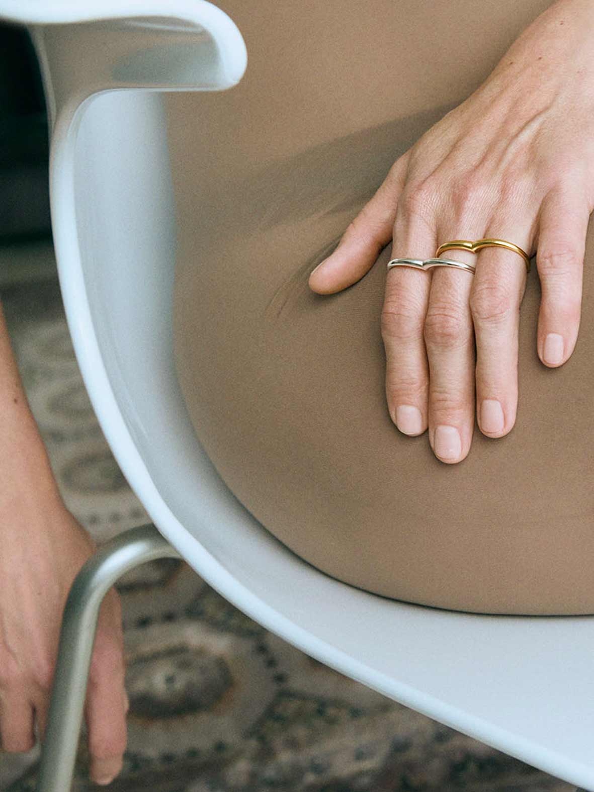 A silver ring with a double circle design for two fingers.