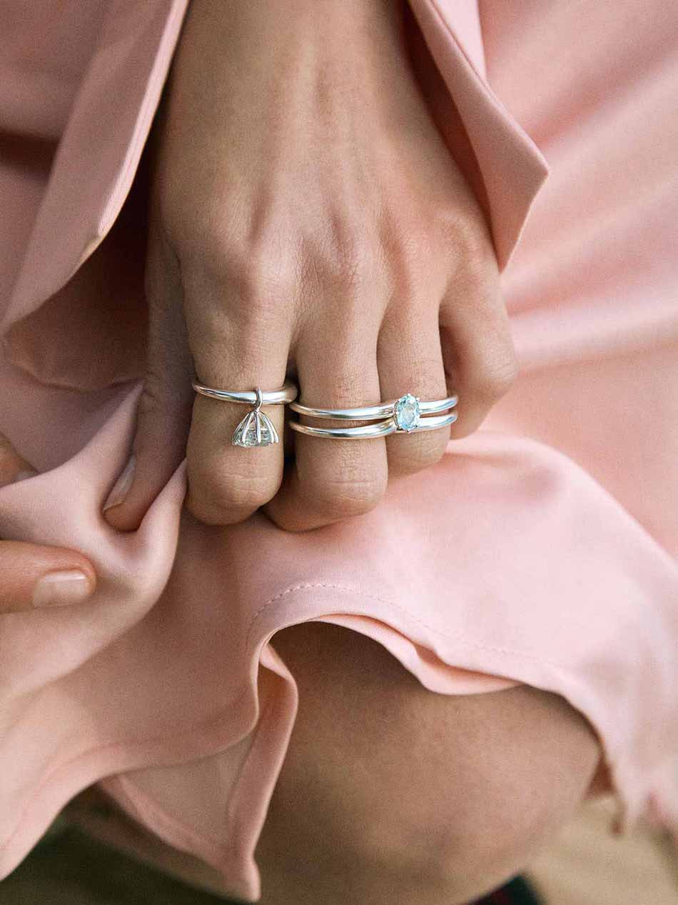 A silver ring with a double circle design for two fingers.