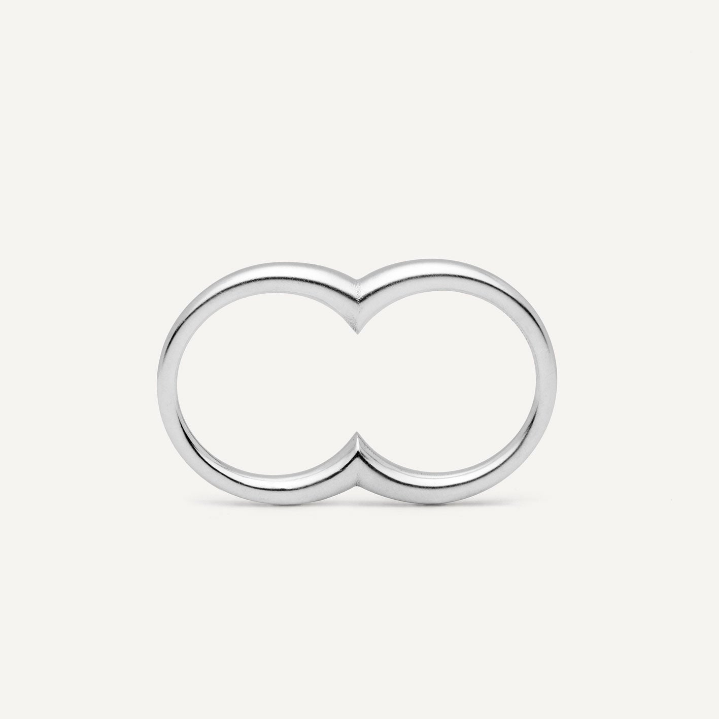 A silver ring with a double circle design for two fingers.