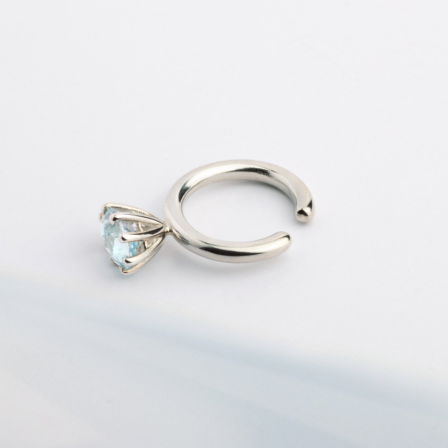 A ear cuff with Blue Topaz gemstone, made of silver. Handmade in Barcelona. No piercing needed. 