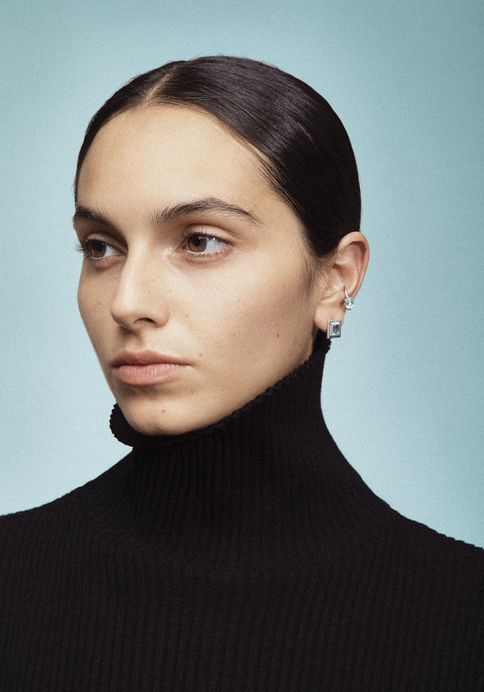 A ear cuff with gemstones, made of silver. Handmade in Barcelona. No piercing needed. 