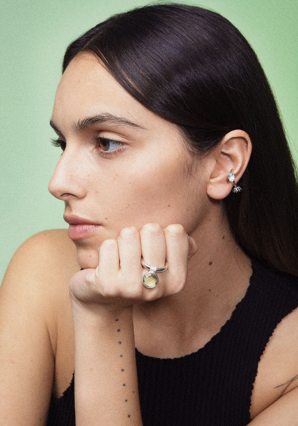 A ear cuff with gemstones, made of silver. Handmade in Barcelona. No piercing needed. 