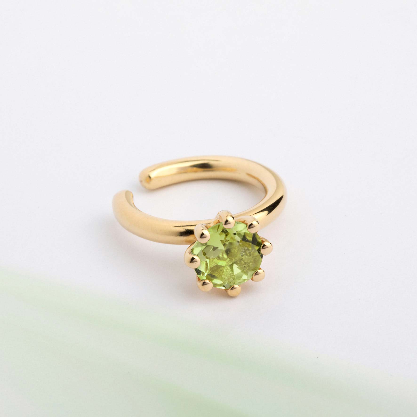 An ear cuff with Green Peridot gemstone, made of 18k yellow gold plated  silver. Handmade in Barcelona. No piercing needed. 