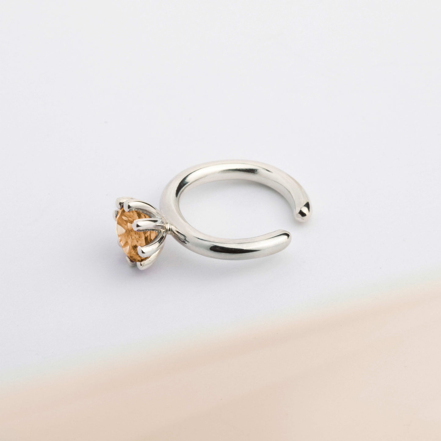 A ear cuff with yellow Citrine gemstone, made of silver. Handmade in Barcelona. No piercing needed. 