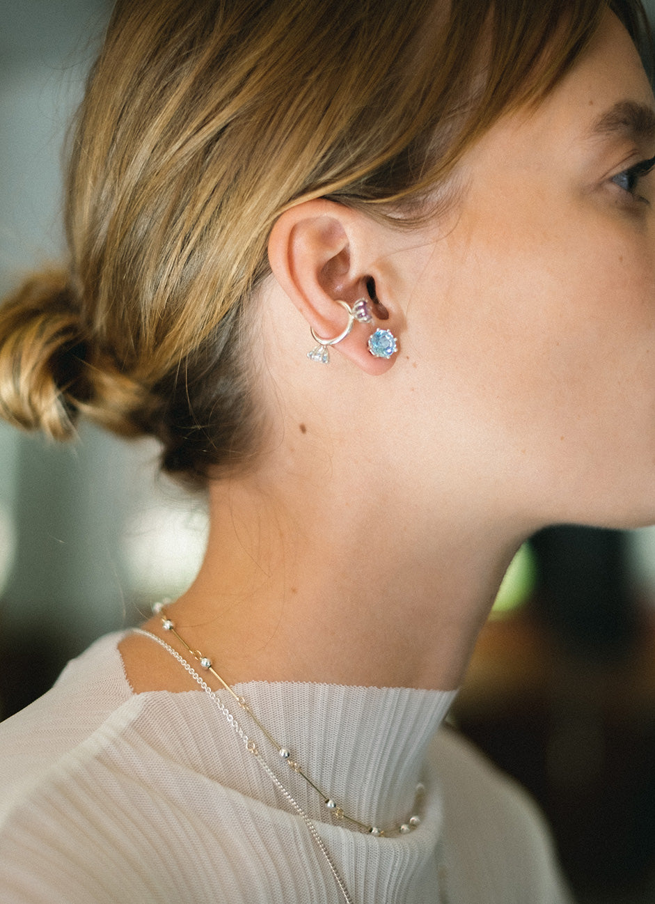 A pair of silver earrings featuring colored gemstone, designed to be worn every day. Handmade in Barcelona. 