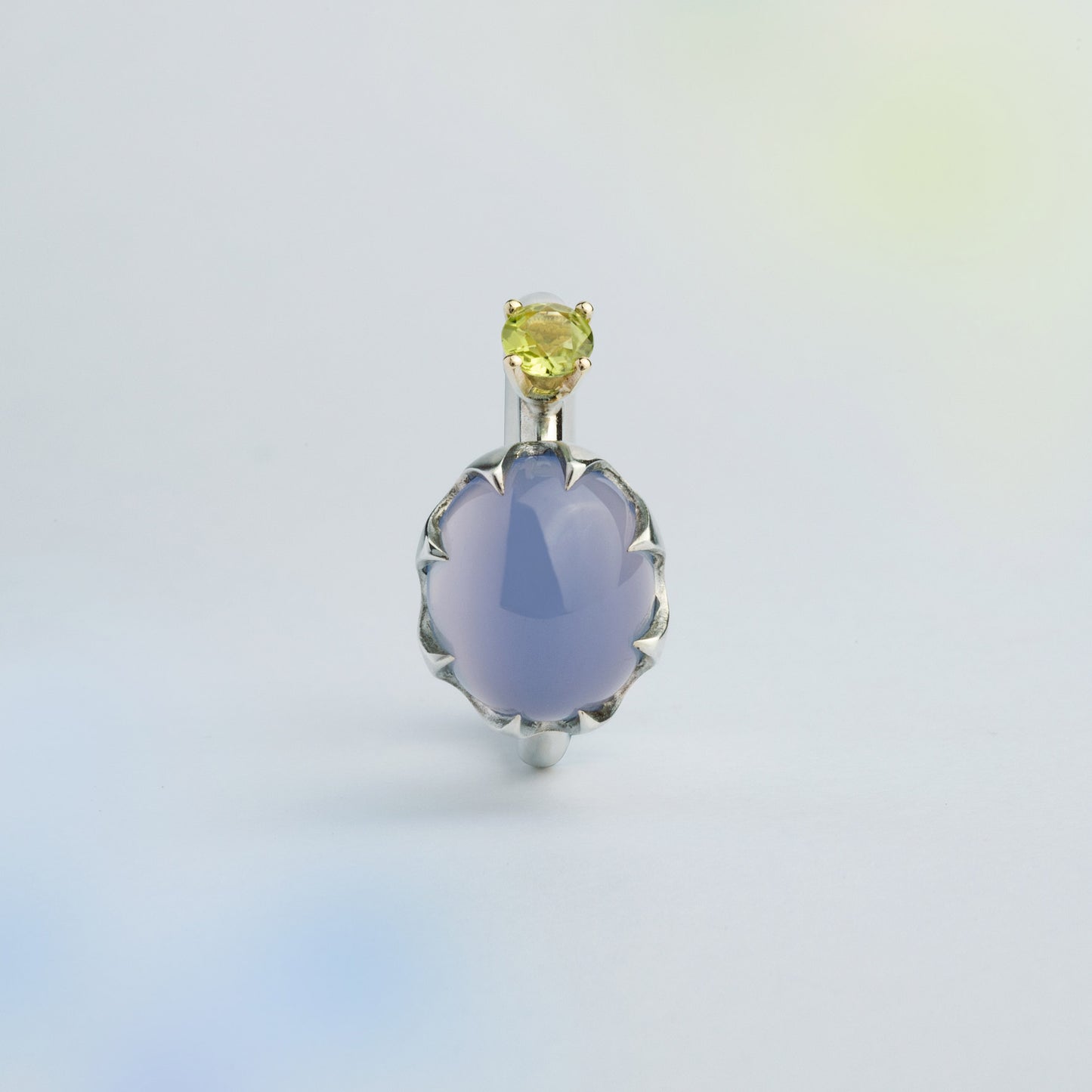 Asymmetric silver ring with a gold setting featuring blue Chalcedony and green Peridot made for inner transformations. Handmade in Barcelona. 