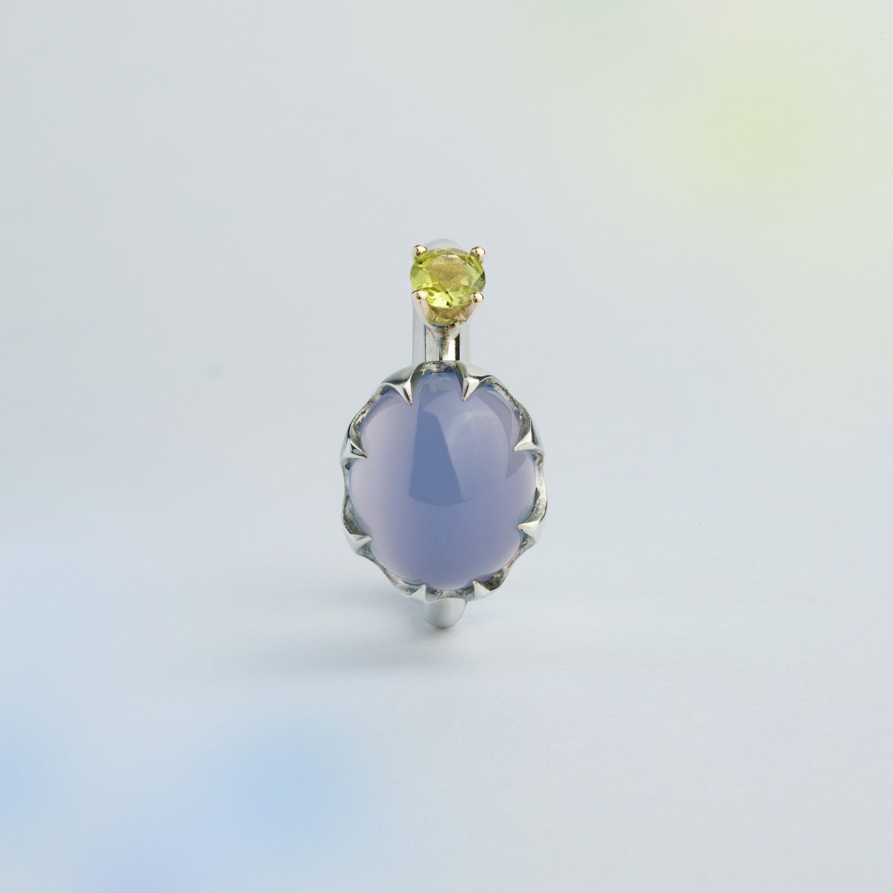 Asymmetric silver ring with a gold setting featuring blue Chalcedony and green Peridot made for inner transformations. Handmade in Barcelona. 