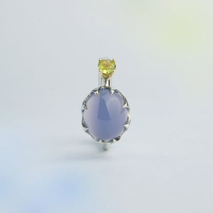 Asymmetric silver ring with a gold setting featuring blue Chalcedony and green Peridot made for inner transformations. Handmade in Barcelona. 