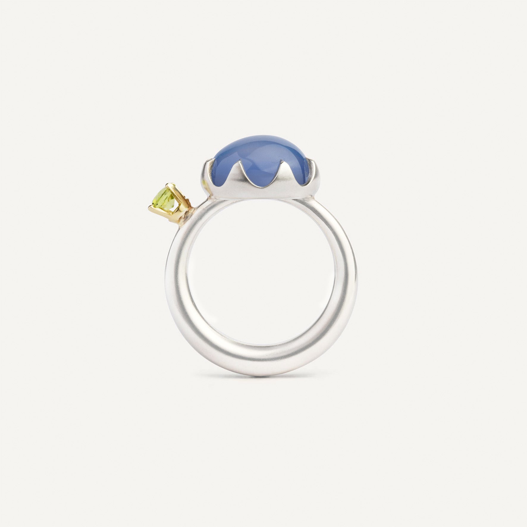 Asymmetric silver ring with a gold setting featuring blue Chalcedony and green Peridot made for inner transformations. Handmade in Barcelona. 