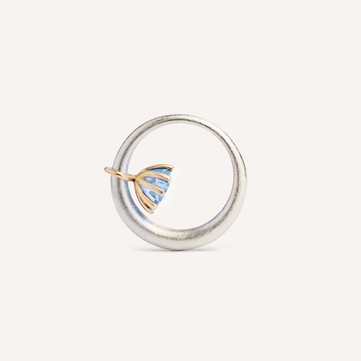 I wanted to make a playful silver ring using a combination of metals — a setting that doesn’t sit still. Here it is: an 18K gold setting with a gemstone that moves along the ring as you move your hand. 