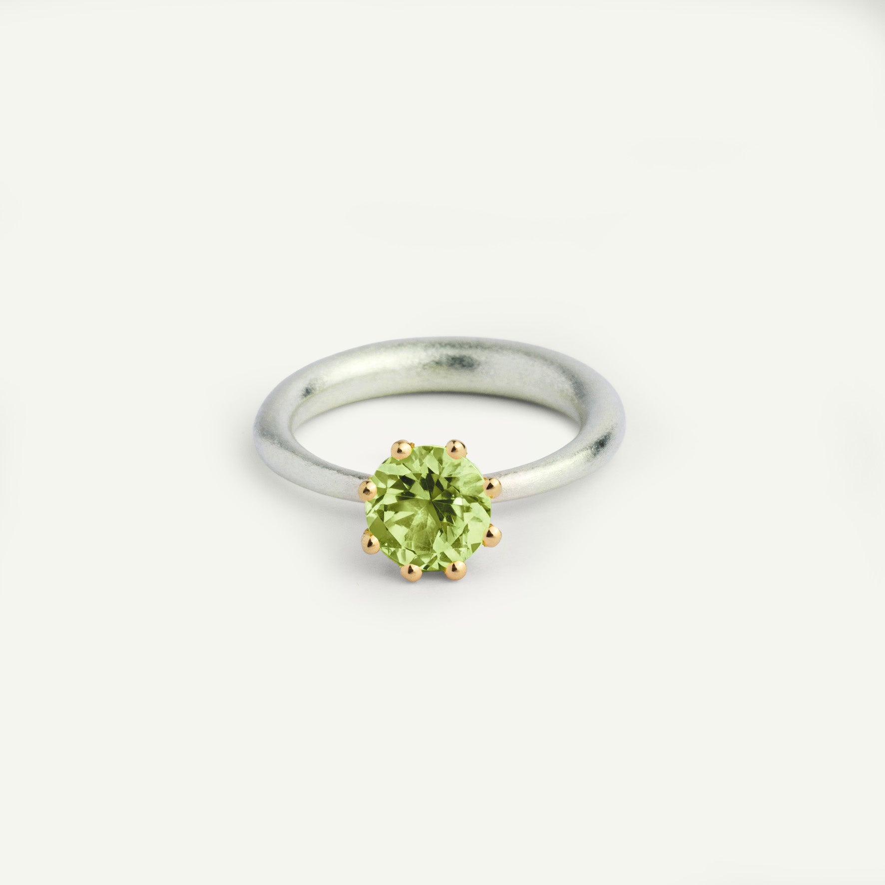 I wanted to make a playful silver ring using a combination of metals — a setting that doesn’t sit still. Here it is: an 18K gold setting with a gemstone that moves along the ring as you move your hand. 