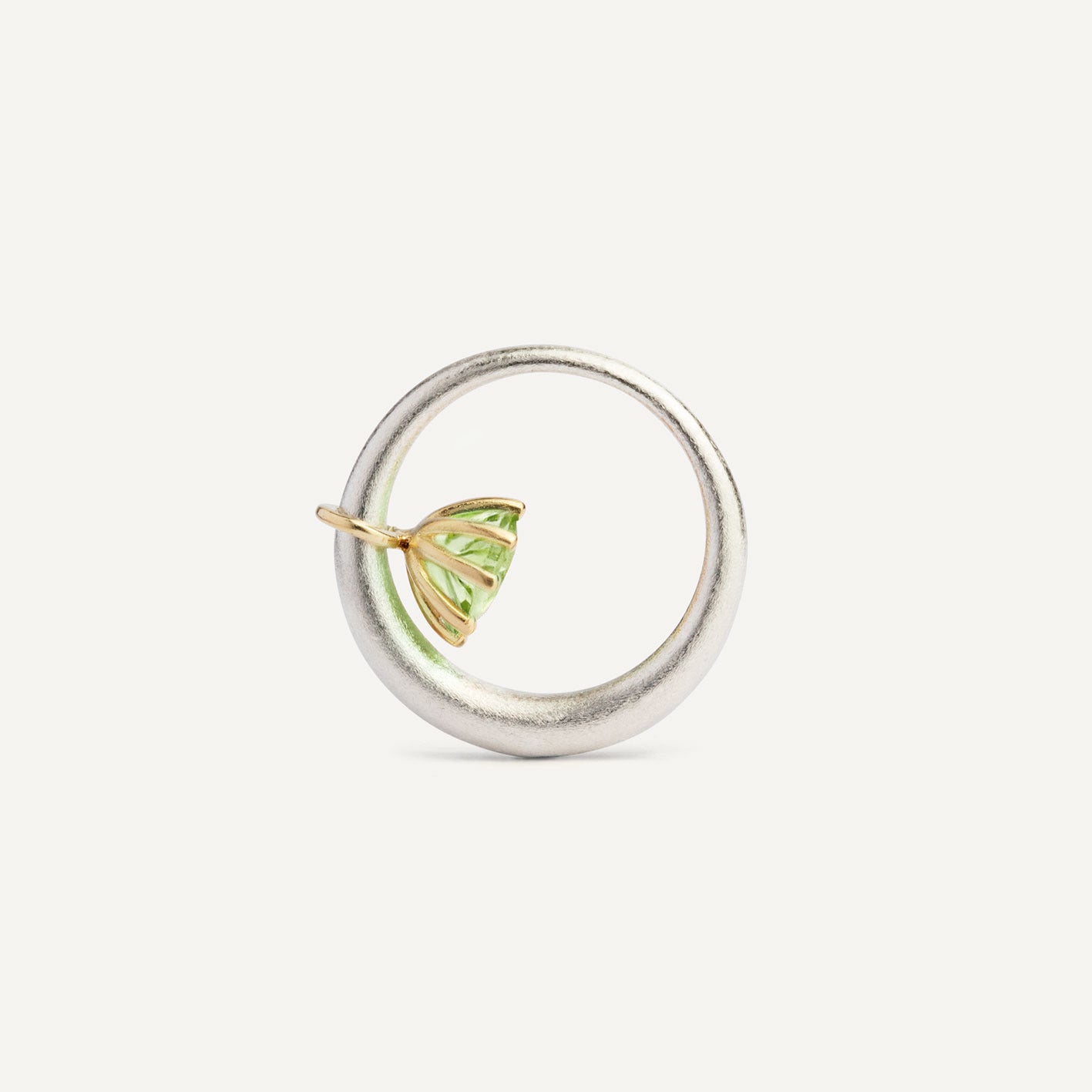 I wanted to make a playful silver ring using a combination of metals — a setting that doesn’t sit still. Here it is: an 18K gold setting with a gemstone that moves along the ring as you move your hand. 