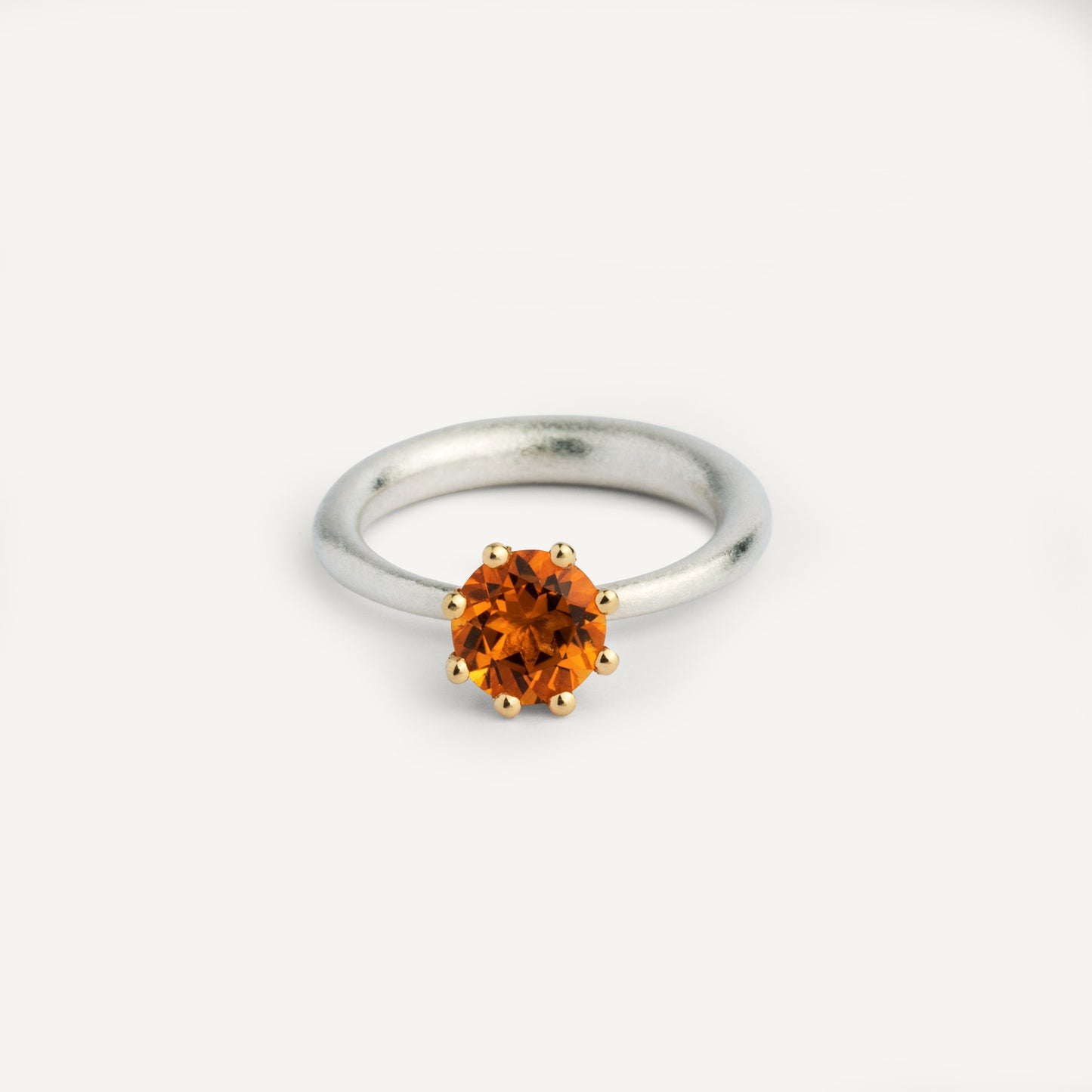 I wanted to make a playful  silver ring using a combination of metals — a setting that doesn’t sit still. Here it is: an 18K gold setting with a gemstone that moves along the ring as you move your hand. 