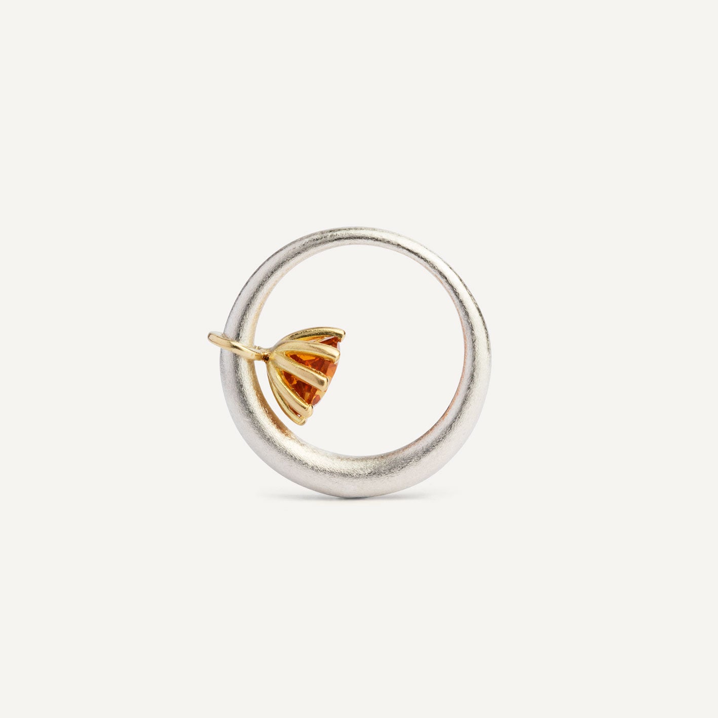 I wanted to make a playful  silver ring using a combination of metals — a setting that doesn’t sit still. Here it is: an 18K gold setting with a gemstone that moves along the ring as you move your hand. 