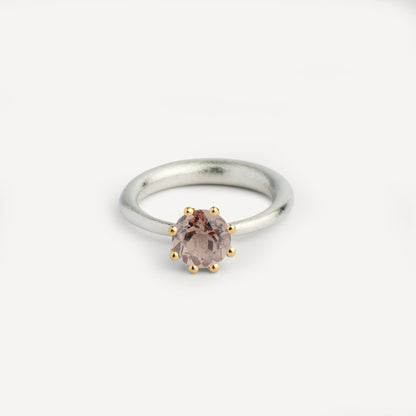 I wanted to make a playful silver ring using a combination of metals — a setting that doesn’t sit still. Here it is: an 18K gold setting with a gemstone that moves along the ring as you move your hand. 