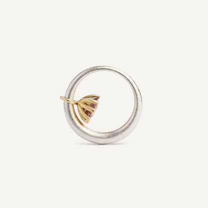 I wanted to make a playful silver ring using a combination of metals — a setting that doesn’t sit still. Here it is: an 18K gold setting with a gemstone that moves along the ring as you move your hand. 