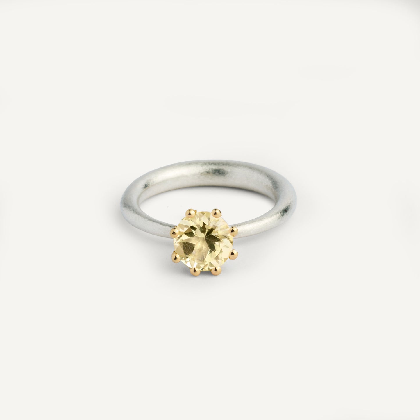 I wanted to make a playful silver ring using a combination of metals — a setting that doesn’t sit still. Here it is: an 18K gold setting with a gemstone that moves along the ring as you move your hand. 