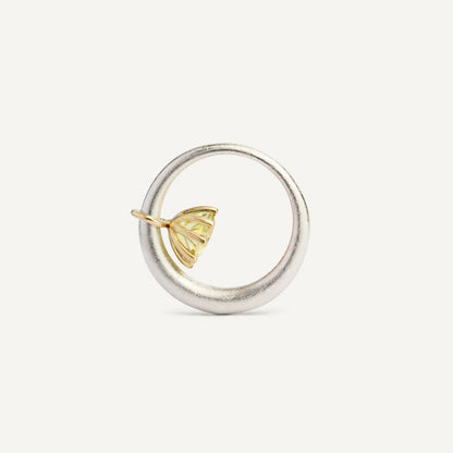 I wanted to make a playful silver ring using a combination of metals — a setting that doesn’t sit still. Here it is: an 18K gold setting with a gemstone that moves along the ring as you move your hand. 