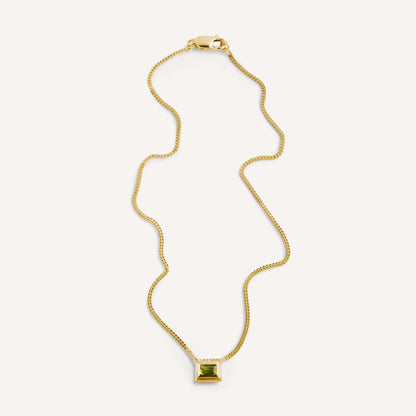 A gold plated silver necklace with a reversible pendant featuring a green Peridot gemstone on one side and violet Amethyst on the other designed for everyday wear.