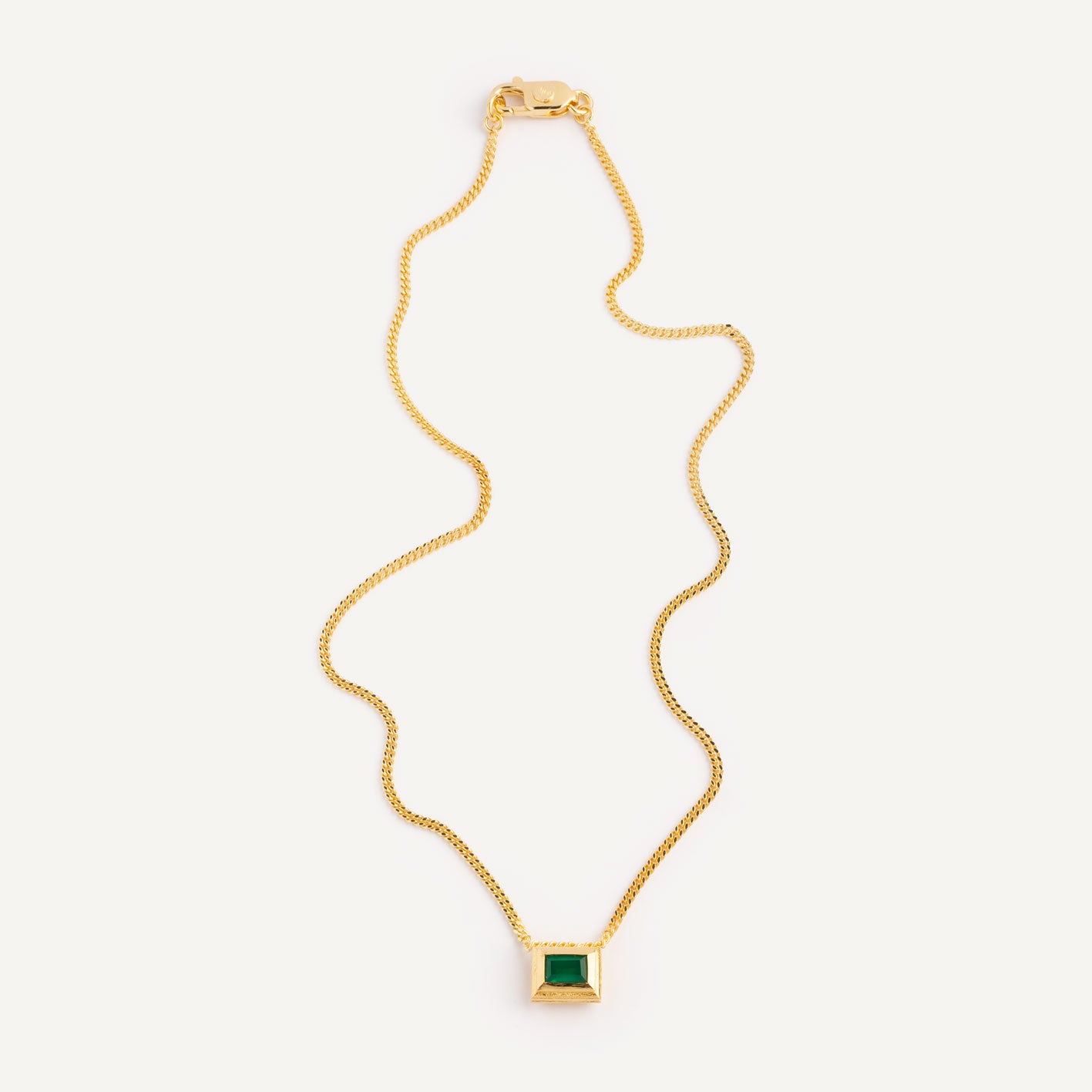 A gold plated silver necklace with a reversible pendant featuring a green Chrysoprase gemstone on one side and blue Topaz on the other designed for everyday wear.